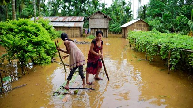 Girls row a makeshift raft past submerged houses at a flood-affected village in Karbi Anglong district, Assam. (Anuwar Hazarika / REUTERS) Girls row a makeshift raft past submerged houses at a flood-affected village in Karbi Anglong district, Assam. (Anuwar Hazarika / REUTERS)