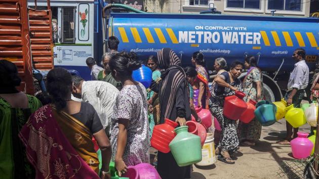 Residents wait in line to fill pots from a truck in Chennai. Almost all of Chennai’s hospitals are now completely dependent on the more than 5,000 privately-owned tankers that ferry water around the city every day, according to N. Nijalingam, president of the Tamil Nadu Private Water Tanker Lorry Owners’ Association. But it’s becoming tougher to source water even from 100 kilometers away, he said. (Dhiraj Singh / Bloomberg)