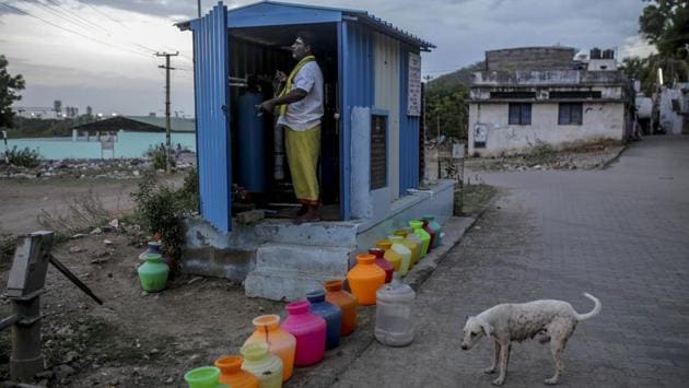 Empty water pots, left to be refilled by a water truck, line a street next to a generator kiosk in a residential area in Chennai. The price of a 12,000-litre water truck soared from 1,200 rupees in April to as high as 6,000 rupees since shortages began, The News Minute website reported. (Dhiraj Singh / Bloomberg)