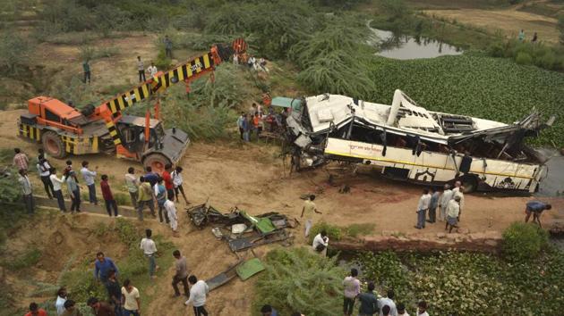 A crane pulls a damaged bus after it broke through the boundary wall of an expressway bridge and plunged into a drain on the outskirts of Agra, Uttar Pradesh. (Pawan Sharma / AP) A crane pulls a damaged bus after it broke through the boundary wall of an expressway bridge and plunged into a drain on the outskirts of Agra, Uttar Pradesh. (Pawan Sharma / AP)