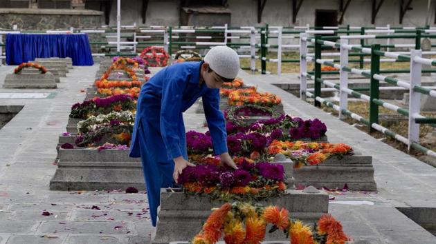 A Kashmiri boy lays a wreath on a grave at Martyrs’ Graveyard in Srinagar, Jammu and Kashmir. July 13 is observed as Martyrs’ Day in memory of the day when the region’s Hindu king ordered more than 20 Kashmiri Muslims executed in a bid to put down an uprising in 1931. (Dar Yasin / AP) A Kashmiri boy lays a wreath on a grave at Martyrs’ Graveyard in Srinagar, Jammu and Kashmir. July 13 is observed as Martyrs’ Day in memory of the day when the region’s Hindu king ordered more than 20 Kashmiri Muslims executed in a bid to put down an uprising in 1931. (Dar Yasin / AP)