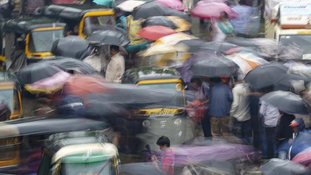 People seen moving on a busy street during the rains near Ghatkopar Station in Mumbai, Maharashtra. (Hemanshi Kamani / HT Photo) People seen moving on a busy street during the rains near Ghatkopar Station in Mumbai, Maharashtra. (Hemanshi Kamani / HT Photo)