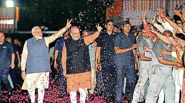 Prime Minister Narendra Modi shows victory sign as he, along with the party President Amit Shah, arrives at the party headquarters to celebrate their victory in the 2019 Lok Sabha elections, in New Delhi, India, on Thursday, May 23, 2019. (Photo by Arvind Yadav/ Hindustan Times) Prime Minister Narendra Modi shows victory sign as he, along with the party President Amit Shah, arrives at the party headquarters to celebrate their victory in the 2019 Lok Sabha elections, in New Delhi, India, on Thursday, May 23, 2019. (Photo by Arvind Yadav/ Hindustan Times)