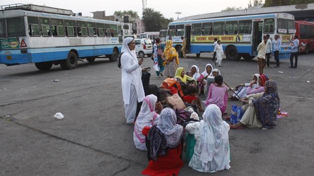 Women commuters wait near buses. The lack of upkeep is visible, but the aforementioned rooms have been taken over by passengers who bode their time in groups, ignoring the barricades, for the sake of a quiet spot to converse with their friends. (Yogendra Kumar / HT Photo)