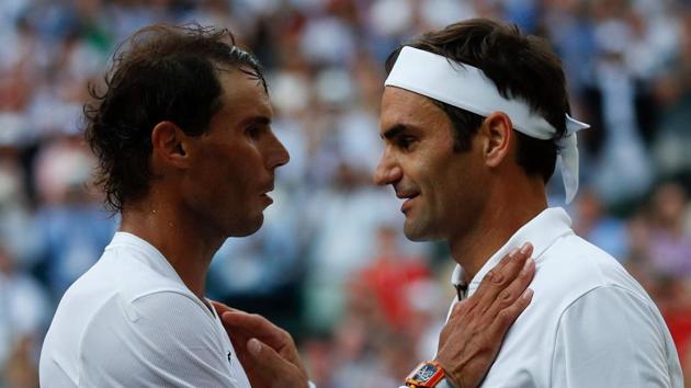 Switzerland's Roger Federer (R) shakes hands and embraces Spain's Rafael Nadal (L).(AFP)
