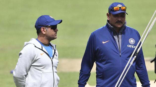 India's MS Dhoni, left, stands with team coach Ravi Shastri(AP)