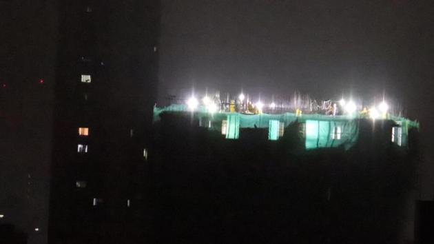 A resident of Kalbadevi took a photo of the construction site with work underway beyond the 10 pm deadline.(HT Photo)