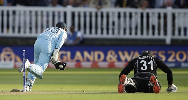 England's Jos Buttler runs out New Zealand's Martin Guptill to win the Cricket World Cup final match. (AP) 