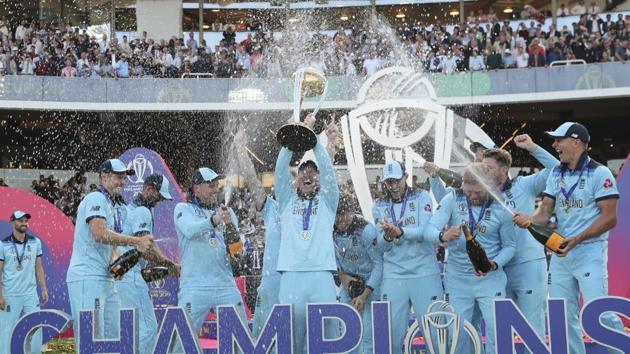 England's captain Eoin Morgan is sprayed with champagne as he raises the trophy after winning the Cricket World Cup.(AP)