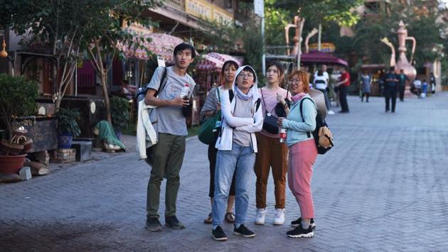 Malaysian tourists seen in the restored old city area of Kashgar. The government has rounded up an estimated one million Uighurs and other mostly Muslim Turkic-speaking minorities into re-education camps in the tightly-controlled region in China’s northwest, but it has also created a parallel universe for visitors, who are only shown a carefully curated version of traditional customs and culture. (Greg Baker / AFP) Malaysian tourists seen in the restored old city area of Kashgar. The government has rounded up an estimated one million Uighurs and other mostly Muslim Turkic-speaking minorities into re-education camps in the tightly-controlled region in China’s northwest, but it has also created a parallel universe for visitors, who are only shown a carefully curated version of traditional customs and culture. (Greg Baker / AFP)