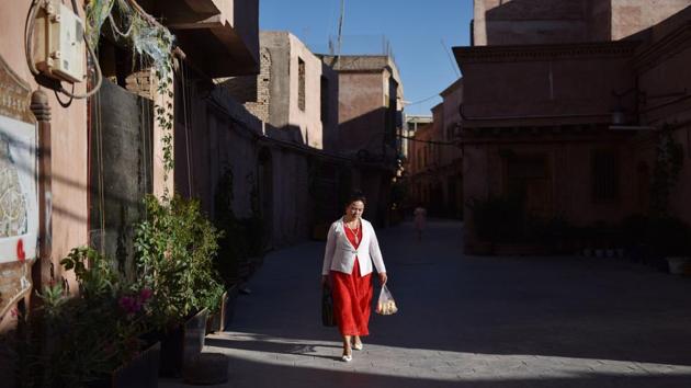 A woman walks in the restored old city area of Kashgar. Xinjiang is one of the fastest growing areas for tourism in China. Armed police and frequent checkpoints have not dampened the flow of vacationers visiting the region, which in 2018 saw a 40 percent increase year-on-year of visits -- mainly from domestic tourists -- outstripping the national average by 25 percent, according to official figures. (Greg Baker / AFP) A woman walks in the restored old city area of Kashgar. Xinjiang is one of the fastest growing areas for tourism in China. Armed police and frequent checkpoints have not dampened the flow of vacationers visiting the region, which in 2018 saw a 40 percent increase year-on-year of visits -- mainly from domestic tourists -- outstripping the national average by 25 percent, according to official figures. (Greg Baker / AFP)