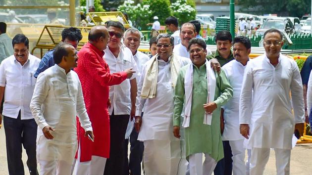 Former Chief Minister and Congress JD(S) coordination committee chairman Siddaramaiah with party MLAs arrives to take part in the State Assembly session at Vidhan Soudha in Bengaluru on Monday. (Photo: PTI) Former Chief Minister and Congress JD(S) coordination committee chairman Siddaramaiah with party MLAs arrives to take part in the State Assembly session at Vidhan Soudha in Bengaluru on Monday. (Photo: PTI)