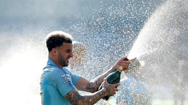 Manchester City's Kyle Walker sprays sparkling wine as he celebrates winning the Premier League.(Action Images via Reuters)