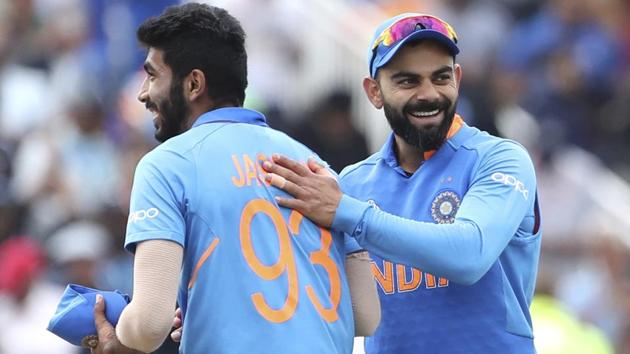 India's captain Virat Kohli, right, celebrates with teammate Jasprit Bumrah.(AP)