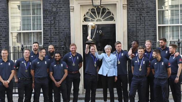 Britain's Prime Minister Theresa May smiles as she stands with England cricket captain Eoin Morgan.(AP)