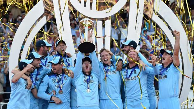 England's captain Eoin Morgan lifts the World Cup trophy as England's players celebrate their win.(AFP)