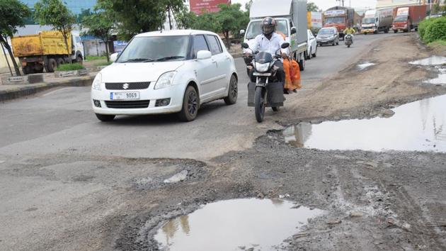 Roads are in bad shape near the Volkswagen dispatch gate at Chakan MIDC, Pune. German representatives have complained of developing backaches due to the pothole-ridden roads in the area. (HT Photo) Roads are in bad shape near the Volkswagen dispatch gate at Chakan MIDC, Pune. German representatives have complained of developing backaches due to the pothole-ridden roads in the area. (HT Photo)