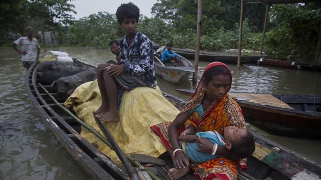 A woman carries her sick son on a boat in the flood-affected Burha Burhi village, east of Guwahati. The Brahmaputra has been rising menacingly above the danger level across the state, swelling up in Guwahati and overflowing its bank in the Uzan Bazar area. (Anupam Nath / AP) A woman carries her sick son on a boat in the flood-affected Burha Burhi village, east of Guwahati. The Brahmaputra has been rising menacingly above the danger level across the state, swelling up in Guwahati and overflowing its bank in the Uzan Bazar area. (Anupam Nath / AP)