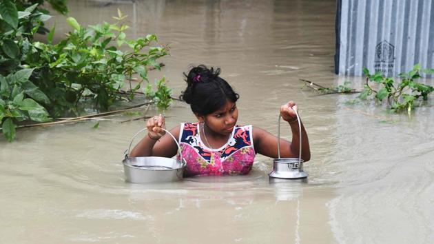 A girl carries drinking water through flood waters at Pabhokathi village in Morigaon district. The ASDMA report said embankments, roads, bridges, culverts and other infrastructure have been damaged at in Sonitpur, Golaghat, Jorhat, Baksa, Dibrugarh, Nalbari, Hojai, Morigaon, Lakhimpur, Darrang, Nagaon, Kamrup, Barpeta, Dhubri, Majuli, Karimganj, Sivasagar, Hailakandi and South Salmara districts. (Biju Boro / AFP) A girl carries drinking water through flood waters at Pabhokathi village in Morigaon district. The ASDMA report said embankments, roads, bridges, culverts and other infrastructure have been damaged at in Sonitpur, Golaghat, Jorhat, Baksa, Dibrugarh, Nalbari, Hojai, Morigaon, Lakhimpur, Darrang, Nagaon, Kamrup, Barpeta, Dhubri, Majuli, Karimganj, Sivasagar, Hailakandi and South Salmara districts. (Biju Boro / AFP)
