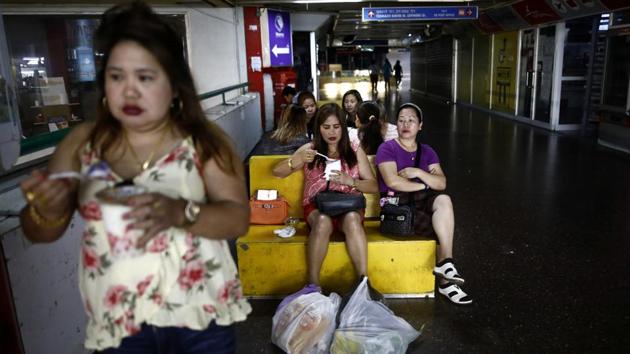 People eat food purchased from a nearby Filipino food market inside the bus station. People eat food purchased from a nearby Filipino food market inside the bus station. The market serves a large community of carers for the elderly, there’s a makeshift Philippine church, a folksy Yiddish book centre and money changers. (Corinna Kern / REUTERS) People eat food purchased from a nearby Filipino food market inside the bus station. People eat food purchased from a nearby Filipino food market inside the bus station. The market serves a large community of carers for the elderly, there’s a makeshift Philippine church, a folksy Yiddish book centre and money changers. (Corinna Kern / REUTERS)