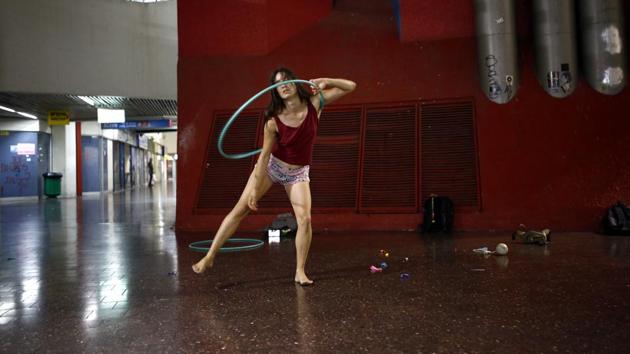 Stav Pinto, 24, employs her circus talents to teach life skills to special needs children. Pinto and her hula hoop take part in an informal circus group that meets on Monday evenings. “There’s a magical air to the Central Bus Station that reminds me of a dark urban forest. It’s a place of adventure where you can meet a variety of people and be exposed to different cultures,” she said. (Corinna Kern / REUTERS) Stav Pinto, 24, employs her circus talents to teach life skills to special needs children. Pinto and her hula hoop take part in an informal circus group that meets on Monday evenings. “There’s a magical air to the Central Bus Station that reminds me of a dark urban forest. It’s a place of adventure where you can meet a variety of people and be exposed to different cultures,” she said. (Corinna Kern / REUTERS)