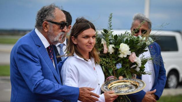 2019 Wimbledon Women's singles champion Simona Halep during her arrival at International Airport in Bucharest.(AFP)
