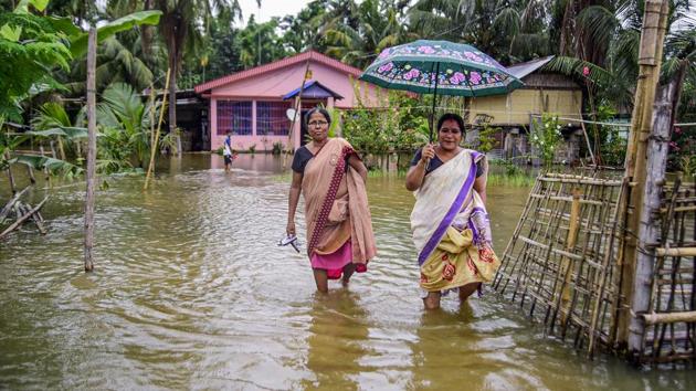 Women wade through flood water at a village following heavy rains, near Kaziranga National Park. At least 17 animals have died due to rain-related incidents since last week in and around the park. Over 95% area of the park is submerged though the water has started receding. A special rhino protection force has also been deployed in vulnerable locations of the park. (PTI) Women wade through flood water at a village following heavy rains, near Kaziranga National Park. At least 17 animals have died due to rain-related incidents since last week in and around the park. Over 95% area of the park is submerged though the water has started receding. A special rhino protection force has also been deployed in vulnerable locations of the park. (PTI)
