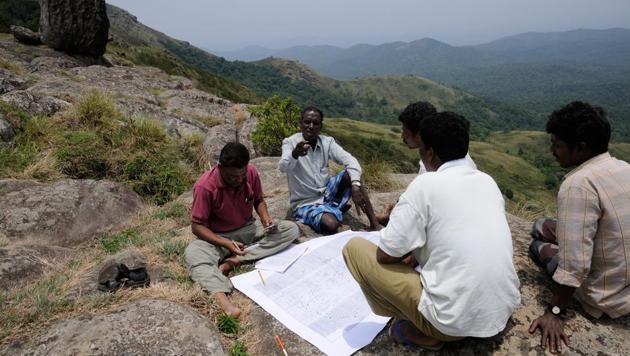 A group of Soliga adivasis in the process of producing a counter-map of the Biligiri Rangaswamy Temple Tiger Reserve, Karnataka. ATREE’S long-term ecological work in BRT shows that restrictions on the use of forests by resident adivasis violates their rights and have several adverse ecological and social outcomes.(NITIN RAI)