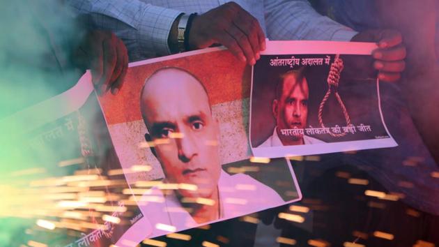 Ahmedabad, India – May 18, 2017: Indians holds posters of Indian naval officer Kulbhushan Jadhav and lights fire crackers as they celebrate the International Court of Justice order on Jadhav, in Ahmadabad, India, Thursday, May 18, 2017. (Photo by )(Siddharaj Solanki/ HT Photo)