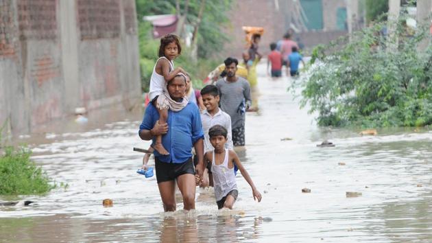 People moving to safer places after water entered their houses in the Gopal Colony locality of Patiala, Punjab, on Tuesday, July 16, 2019.(Bharat Bhushan / HT Photo)