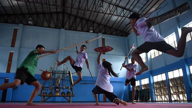 Students practising Krabi Krabong, a Thai martial art, at the Thonburee Woratapeepalarak school in Thonburi, on the outskirts of Bangkok.(AFP)