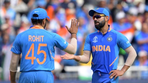 India's captain Virat Kohli (R) celebrates with India's India's Rohit Sharma the wicket of New Zealand's Matt Henry for one during the 2019 Cricket World Cup first semi-final between New Zealand and India at Old Trafford in Manchester, northwest England, on July 10, 2019. (Photo by Dibyangshu Sarkar / AFP) / RESTRICTED TO EDITORIAL USE (AFP) India's captain Virat Kohli (R) celebrates with India's India's Rohit Sharma the wicket of New Zealand's Matt Henry for one during the 2019 Cricket World Cup first semi-final between New Zealand and India at Old Trafford in Manchester, northwest England, on July 10, 2019. (Photo by Dibyangshu Sarkar / AFP) / RESTRICTED TO EDITORIAL USE (AFP)