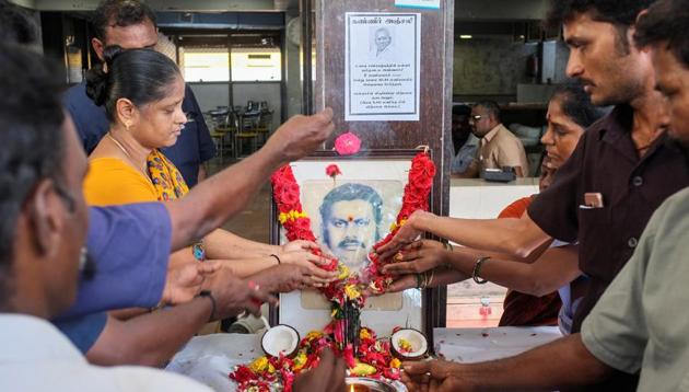Employees pay tribute in front of a portrait of P. Rajagopal, founder of Saravana Bhavan. P Rajagopal (72) died in a Chennai hospital today, two days after he was shifted from jail where he was serving life term for murdering his employee. The Madras High Court had on Tuesday allowed Rajagopal to seek treatment at a private hospital for several health issues following which he was shifted from government Stanley Hospital where he was being treated in the prison ward. (P. Ravikumar / REUTERS)