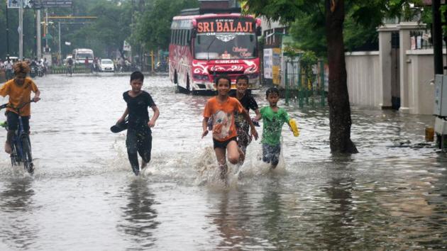 Children play on a water-logged road following heavy monsoon rain in Varanasi, Thursday, July 11, 2019. A flood alert has been sounded for 15 districts of east UP following heavy rain in the region.(PTI)