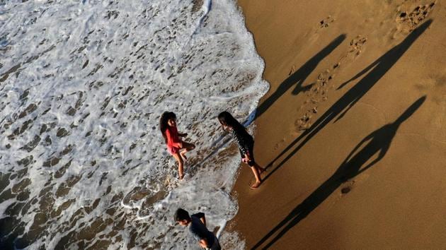 Children enjoy the tide on a beach in the city of Vina del Mar, Chile. (Rodrigo Garrido / REUTERS) Children enjoy the tide on a beach in the city of Vina del Mar, Chile. (Rodrigo Garrido / REUTERS)