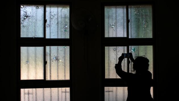A woman uses her mobile phone to take pictures of bullet holes in windows damaged during the attack on the Divine Mercy Church last year when a group of demonstrators protested against Nicaraguan President Daniel Ortega’s government in Managua, Nicaragua. (Oswaldo Rivas / REUTERS) A woman uses her mobile phone to take pictures of bullet holes in windows damaged during the attack on the Divine Mercy Church last year when a group of demonstrators protested against Nicaraguan President Daniel Ortega’s government in Managua, Nicaragua. (Oswaldo Rivas / REUTERS)