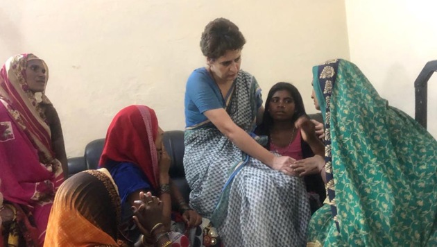 Congress general secretary Priyanka Gandhi Vadra in Chunar fort on Saturday with families of the 10 people killed in a land dispute in UP’s Sonbhadra.(Twitter/Congress)