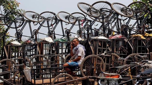 A man speaks on his mobile phone among parked trishaws in Kolkata, West Bengal. (Rupak De Chowdhuri / REUTERS) 