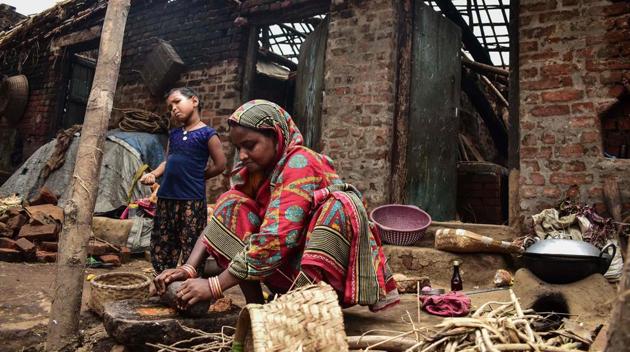 A woman cooks outside her house destroyed by the cyclone "Fani" in the Pratap Purushottampur village area of Puri in Odisha on May 10, 2019.(AFP File Photo)