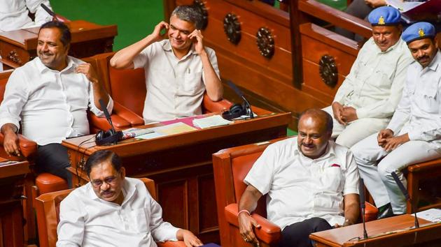 Karnataka Chief Minister HD Kumaraswamy, his deputy G Parameshwara and cabinet colleagues gesture during Assembly Session at Vidhana Soudha, in Bengaluru on Friday. (PTI) Karnataka Chief Minister HD Kumaraswamy, his deputy G Parameshwara and cabinet colleagues gesture during Assembly Session at Vidhana Soudha, in Bengaluru on Friday. (PTI)