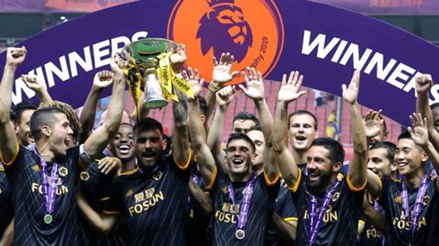 Wolverhampton Wanderers' Conor Coady and Ruben Neves lift the trophy as they celebrate winning the Premier League Asia Trophy. (REUTERS)