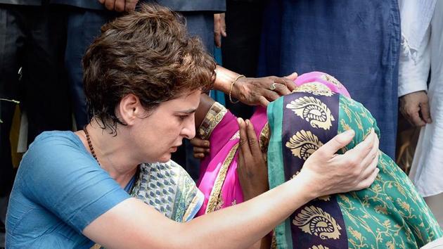 Congress General Secretary Priyanka Gandhi Vadra consoles a Sonbhadra massacre victim’s family member, who had travelled to Chunar Fort to meet Vadra after the she was stopped from proceeding to Sonbhadra, in Mirzapur, Uttar Pradesh. At least 10 people were killed in a shooting on Wednesday over a land dispute in Sonbhadra. (PTI) 