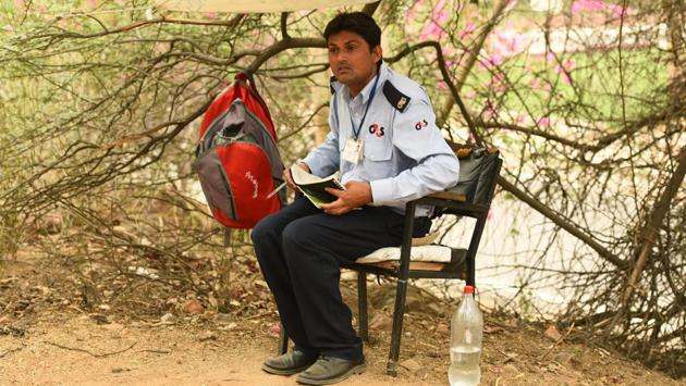 Ramjal Meena, a private security guard seen on duty, outside Godavari hostel, at Jawaharlal Nehru University, New Delhi. Meena cleared the university's entrance exam for a BA in Russian Studies. A resident of Rajasthan, he has been working in JNU since 2014 and said that he was impressed by the academic environment of JNU and decided to sit for the exam. (Vipin Kumar / HT Photo) 