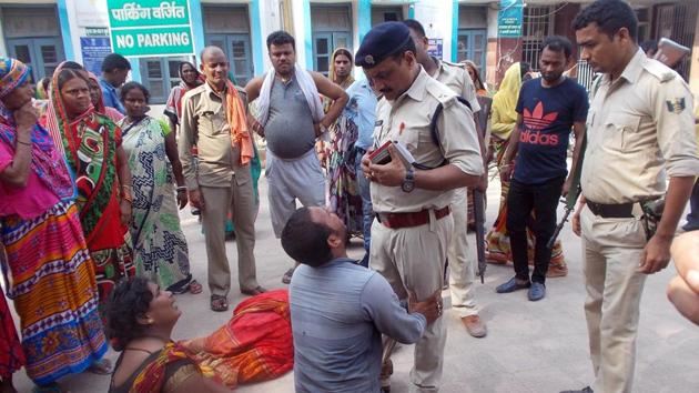 Relatives of the victims of a mob lynching incident speak to a police officer as they mourn outside a hospital in Chapra in Bihar. (REUTERS) 