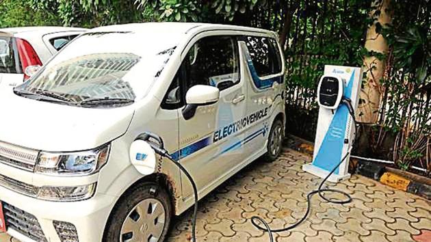 An electric vehicle at a charging point in a residential condominium in Gurugram.(parveen kumar/representational image)