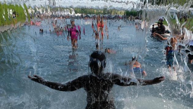 People cool off at a park in the Navy Yard neighborhood on July 20, 2019 in Washington, DC. An excessive heat warning remains in effect throughout the weekend according to the National Weather Service. (AFP FILE) People cool off at a park in the Navy Yard neighborhood on July 20, 2019 in Washington, DC. An excessive heat warning remains in effect throughout the weekend according to the National Weather Service. (AFP FILE)