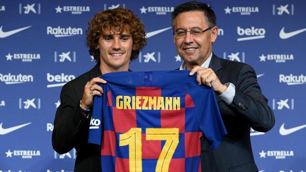 Antoine Griezmann poses with his new Barcelona jersey next to club's president Josep Maria Bartomeu (R) during his official presentation at Camp Nou .(AFP)