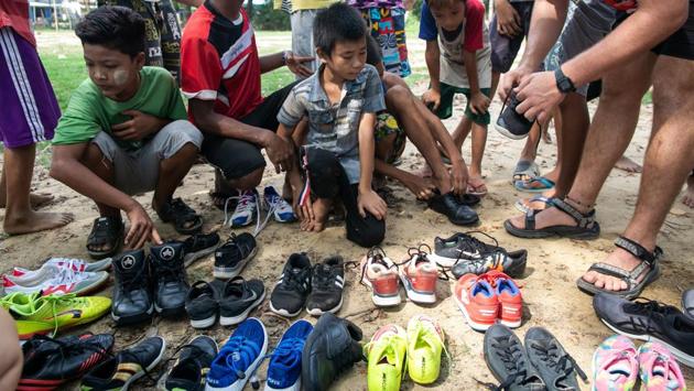 Players from the Little Dragons rugby team choose pairs of donated secondhand shoes during a training session. In the monsoon the training ground is shin-deep in mud, but during the hot season the surface is baked into an unyielding, crusty mosaic. Yet many of the Little Dragons play in bare feet. (Sai Aung Main / AFP) Players from the Little Dragons rugby team choose pairs of donated secondhand shoes during a training session. In the monsoon the training ground is shin-deep in mud, but during the hot season the surface is baked into an unyielding, crusty mosaic. Yet many of the Little Dragons play in bare feet. (Sai Aung Main / AFP)
