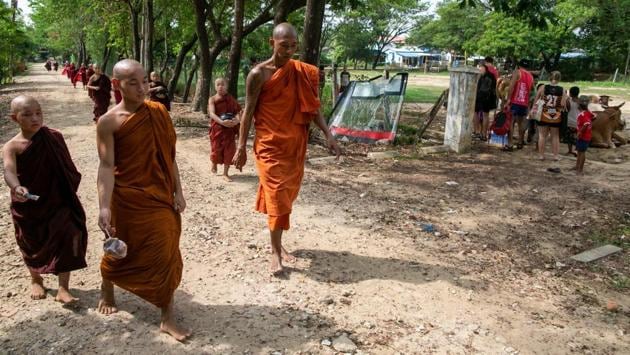 As novice monks file past collecting alms, the players shoo away cantankerous cattle to begin warm-up drills under the tutelage of their coaches, a mix of locals and expatriates. (Sai Aung Main / AFP) As novice monks file past collecting alms, the players shoo away cantankerous cattle to begin warm-up drills under the tutelage of their coaches, a mix of locals and expatriates. (Sai Aung Main / AFP)