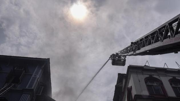 Firefighters attempt to douse a fire at Churchill Chambers near Taj Mahal Hotel, in Colaba, on Sunday. (HT Photo)